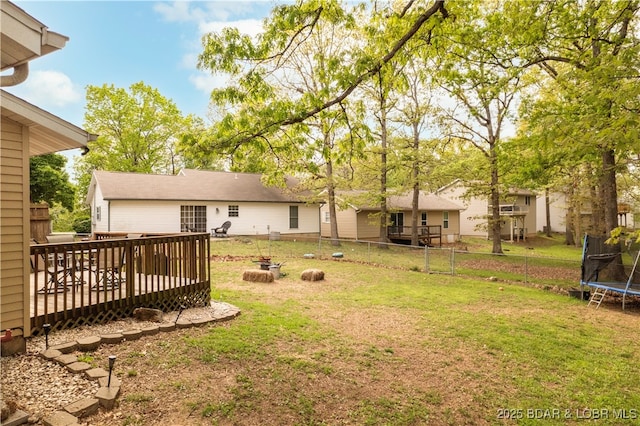 1497 Cherokee Rd W, Lake Ozark, MO 65049 - view of yard featuring a trampoline, an outdoor fire pit, fence, and a deck