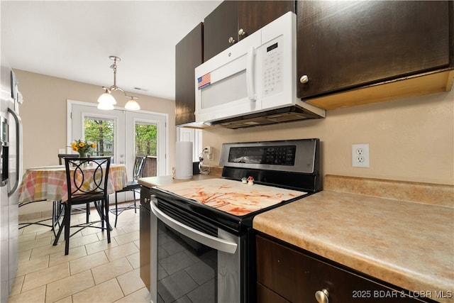1497 Cherokee Rd W, Lake Ozark, MO 65049 - kitchen featuring dark brown cabinets, stainless steel electric range, light countertops, french doors, and white microwave