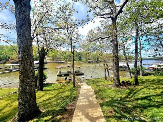 589 Cable Point Dr, Climax Springs, MO 65324 - view of home's community featuring a lawn, a water view, fence, and a dock