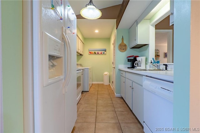 294 Moongate Dr, Osage Beach, MO 65065 - kitchen with a sink, light countertops, light tile patterned floors, white cabinets, and white appliances