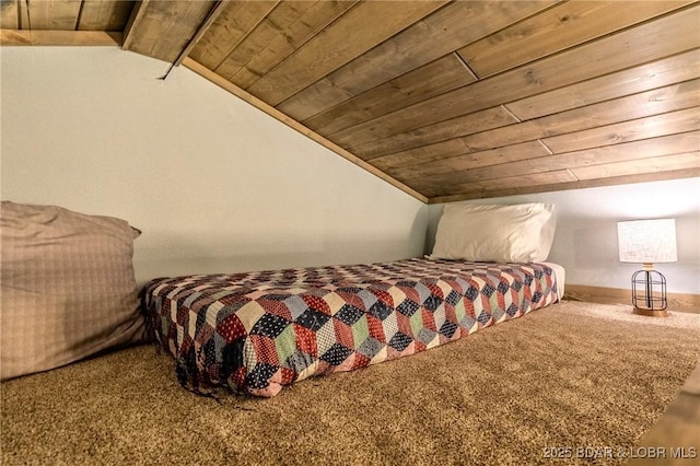 bedroom featuring carpet flooring, wood ceiling, and vaulted ceiling
