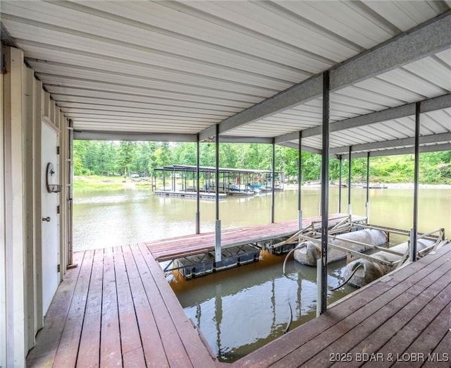 dock area with a water view and boat lift