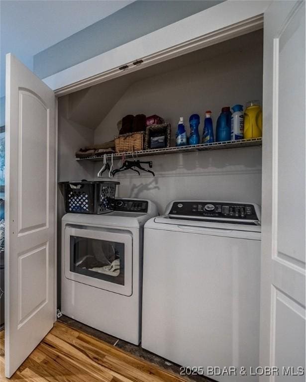 clothes washing area featuring laundry area, separate washer and dryer, and light wood-type flooring