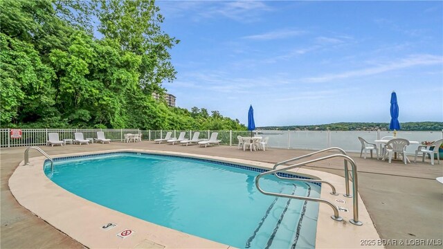 72 Emerald Bay Dr Unit 2D, Lake Ozark, MO 65049 - community pool featuring outdoor dining area, a patio area, and fence