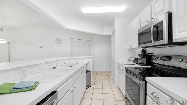 72 Emerald Bay Dr Unit 2D, Lake Ozark, MO 65049 - kitchen featuring white cabinets, stainless steel appliances, a sink, and light countertops