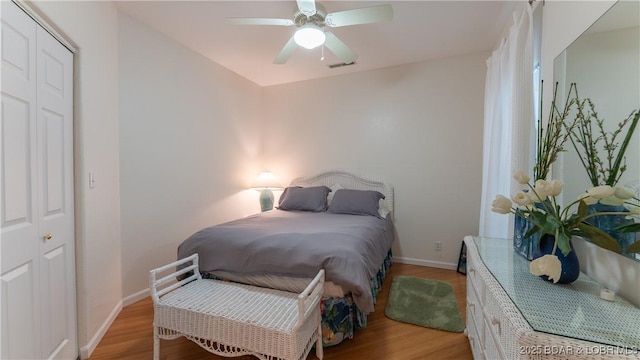 72 Emerald Bay Dr Unit 2D, Lake Ozark, MO 65049 - bedroom with visible vents, a ceiling fan, light wood finished floors, and baseboards