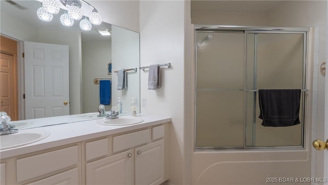 72 Emerald Bay Dr Unit 2D, Lake Ozark, MO 65049 - full bathroom with visible vents, double vanity, a sink, and enclosed tub / shower combo