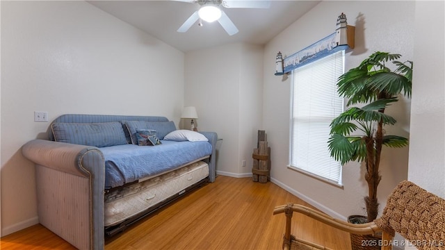 72 Emerald Bay Dr Unit 2D, Lake Ozark, MO 65049 - bedroom with baseboards, multiple windows, and light wood-style floors