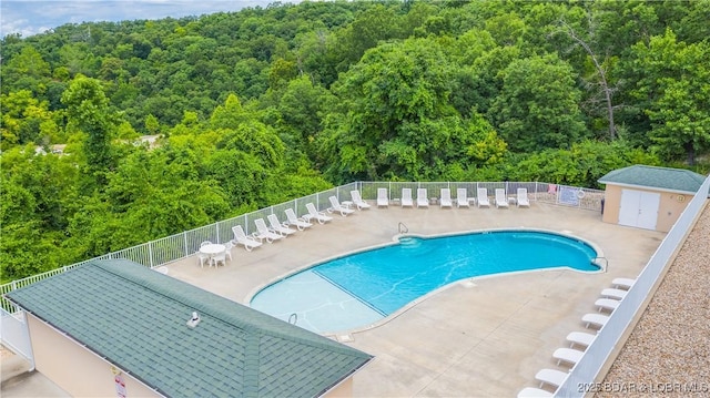 72 Emerald Bay Dr Unit 2D, Lake Ozark, MO 65049 - community pool featuring fence, a patio area, and a wooded view