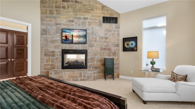 559 Forestridge Ln, Sunrise Beach, MO 65079 - bedroom featuring vaulted ceiling, a stone fireplace, carpet flooring, and baseboards