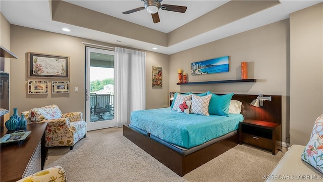 559 Forestridge Ln, Sunrise Beach, MO 65079 - carpeted bedroom with access to exterior, recessed lighting, a ceiling fan, and a tray ceiling