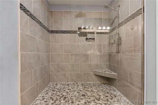 bathroom with tiled shower