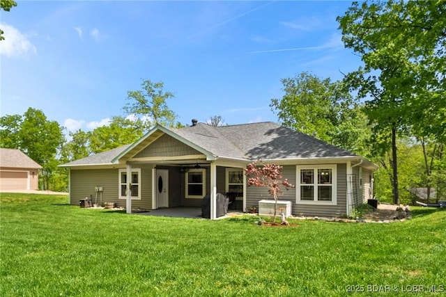 back of house with a patio area and a yard