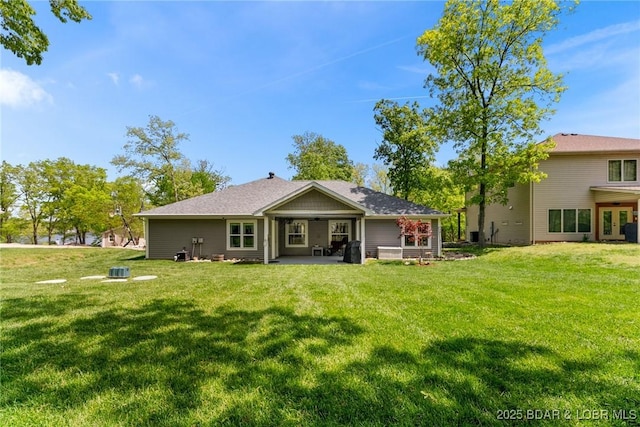 back of house featuring a patio and a yard