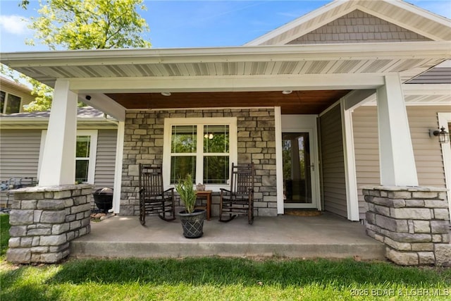 exterior space with covered porch and stone siding