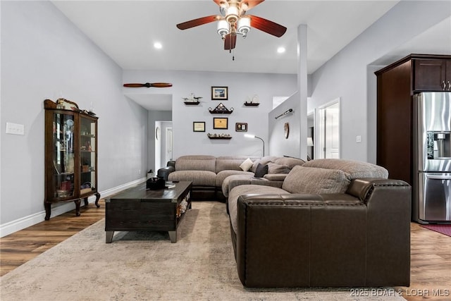 living room featuring recessed lighting, a ceiling fan, and light wood-style flooring