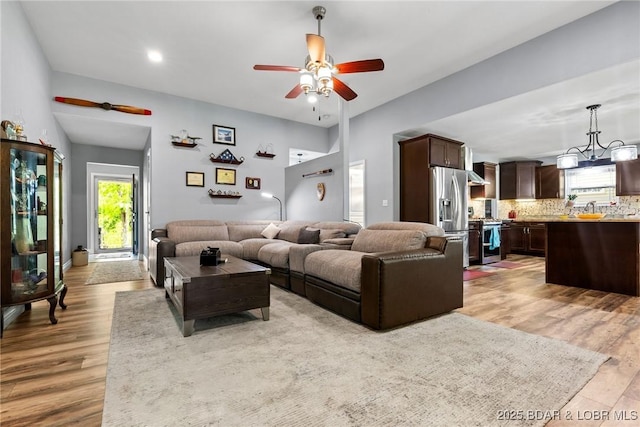 living room with recessed lighting, ceiling fan, and light wood finished floors