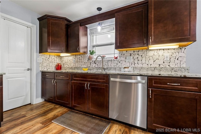 kitchen featuring light stone counters, decorative backsplash, wood finished floors, and dishwasher