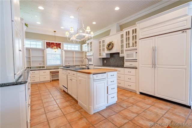 188 Bur Oaks Rd, Camdenton, MO 65020 - kitchen with white appliances, a chandelier, white cabinetry, crown molding, and light tile patterned floors