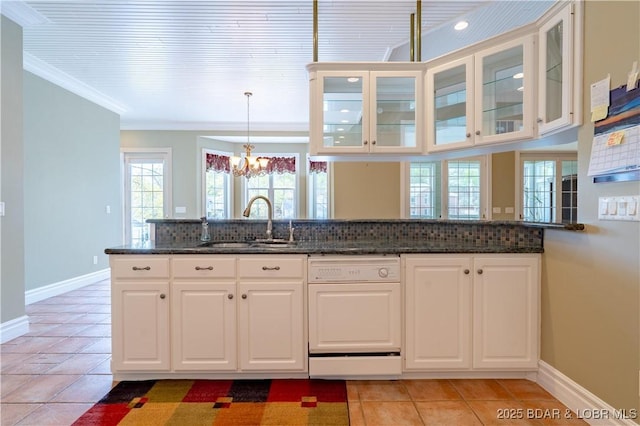 188 Bur Oaks Rd, Camdenton, MO 65020 - kitchen featuring dishwasher, light tile patterned floors, a chandelier, dark stone countertops, and crown molding