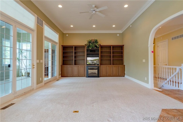 188 Bur Oaks Rd, Camdenton, MO 65020 - unfurnished living room with arched walkways, light colored carpet, ornamental molding, a ceiling fan, and recessed lighting