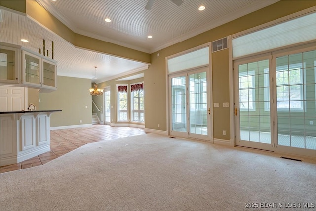 188 Bur Oaks Rd, Camdenton, MO 65020 - unfurnished living room featuring crown molding, recessed lighting, light tile patterned floors, light colored carpet, and a chandelier