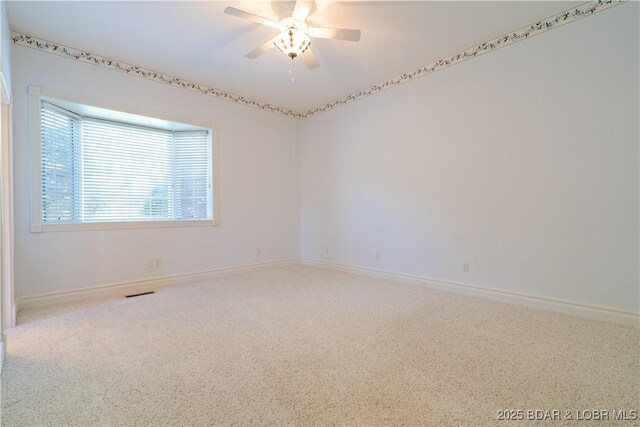 188 Bur Oaks Rd, Camdenton, MO 65020 - carpeted spare room with baseboards and a ceiling fan