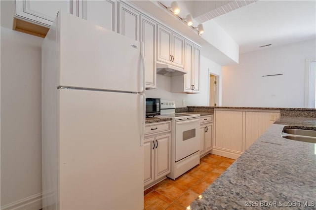 188 Bur Oaks Rd, Camdenton, MO 65020 - kitchen featuring white appliances, under cabinet range hood, light stone counters, and light tile patterned floors