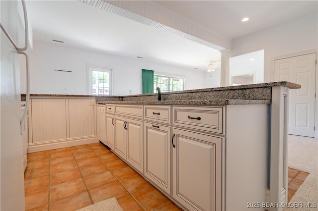 188 Bur Oaks Rd, Camdenton, MO 65020 - kitchen with cream cabinetry, white appliances, a ceiling fan, and stone countertops