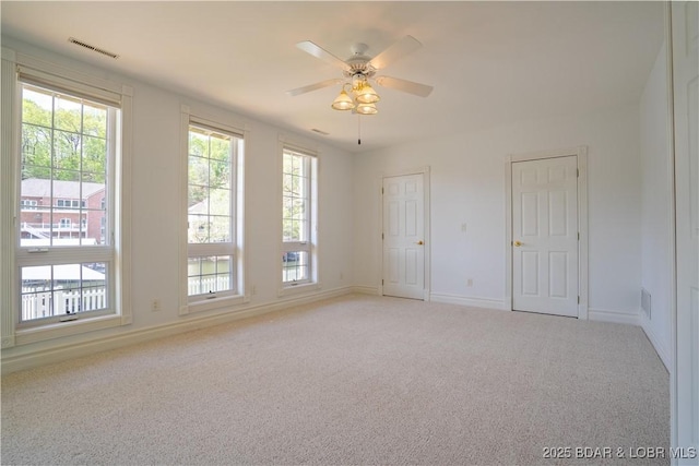 188 Bur Oaks Rd, Camdenton, MO 65020 - unfurnished room featuring light carpet, healthy amount of natural light, and ceiling fan