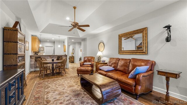living room featuring baseboards, recessed lighting, ceiling fan, and wood finished floors