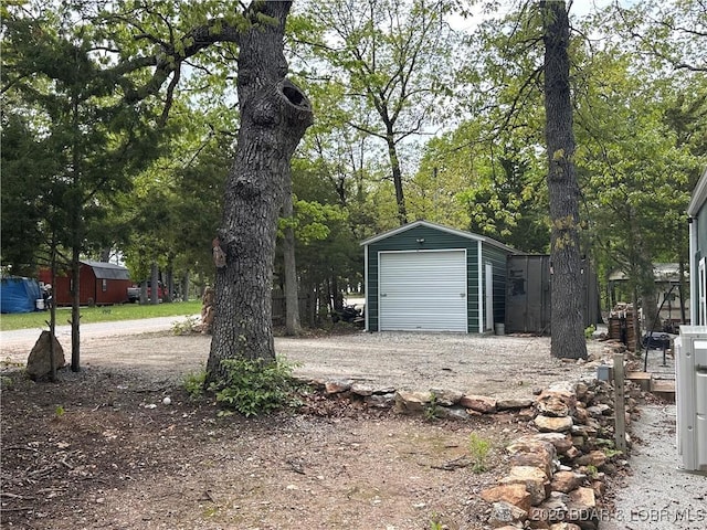 detached garage with dirt driveway