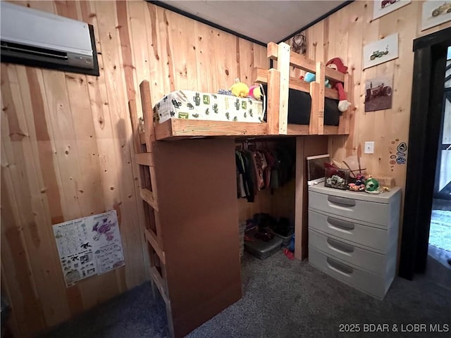 carpeted bedroom with wooden walls and a wall mounted air conditioner
