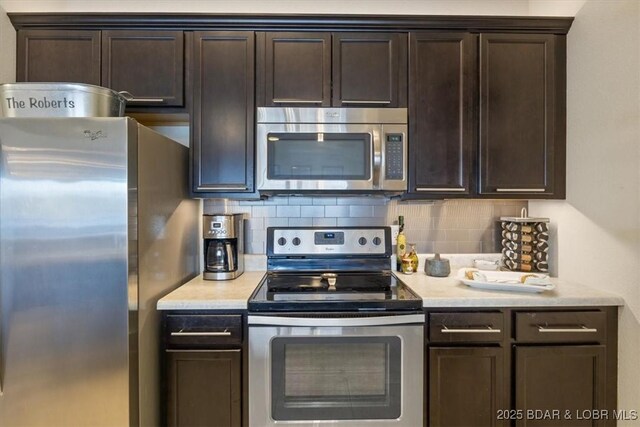 62 Knox Rd Unit 503, Rocky Mount, MO 65072 - kitchen with light countertops, dark brown cabinetry, stainless steel appliances, and backsplash