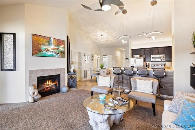 62 Knox Rd Unit 503, Rocky Mount, MO 65072 - carpeted living area featuring high vaulted ceiling, a ceiling fan, and a tile fireplace