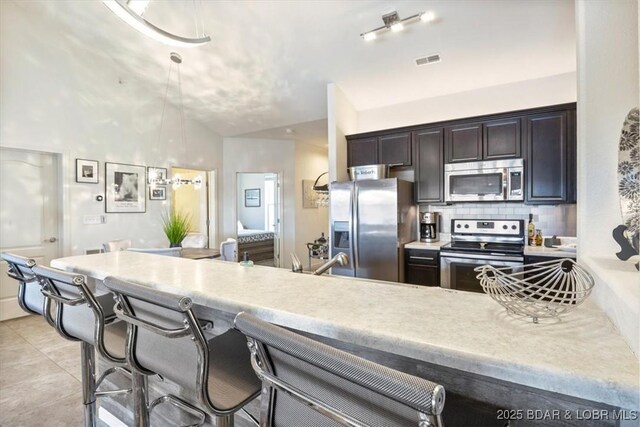 62 Knox Rd Unit 503, Rocky Mount, MO 65072 - kitchen with visible vents, light countertops, appliances with stainless steel finishes, and a kitchen bar