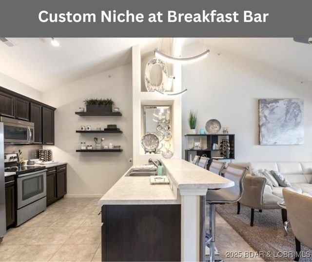 62 Knox Rd Unit 503, Rocky Mount, MO 65072 - kitchen featuring open floor plan, light countertops, a sink, vaulted ceiling, and stainless steel appliances