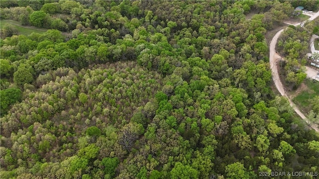 drone / aerial view featuring a forest view