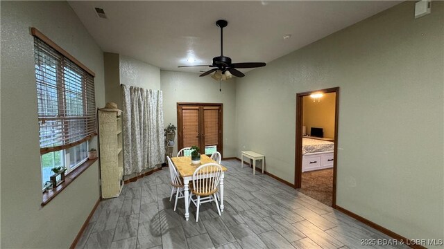 dining space with baseboards, plenty of natural light, ceiling fan, and visible vents