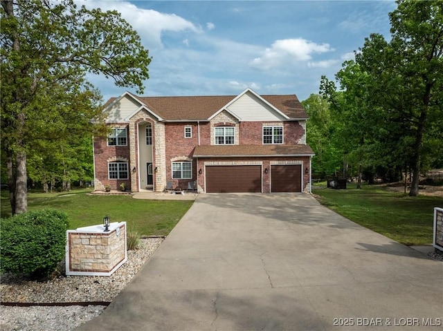 traditional home with brick siding, an attached garage, driveway, and a front yard