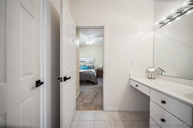 bathroom featuring vanity, a ceiling fan, baseboards, and tile patterned flooring