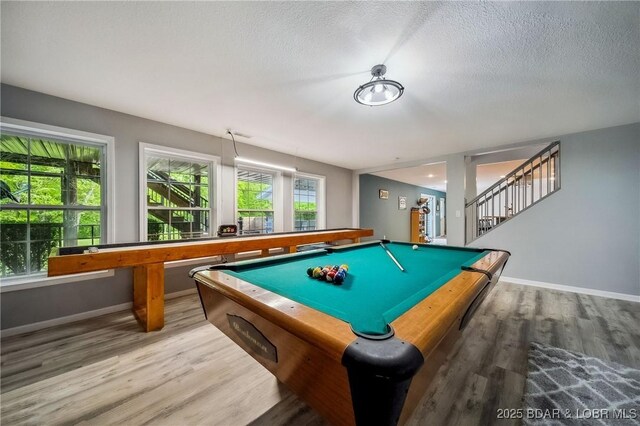 rec room featuring baseboards, a textured ceiling, wood finished floors, and pool table