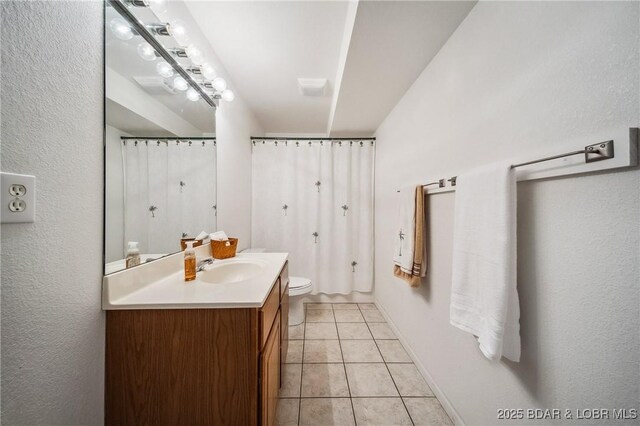 full bathroom with tile patterned flooring, a shower with curtain, toilet, and vanity