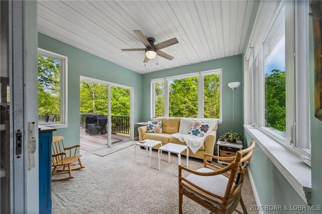sunroom / solarium featuring wooden ceiling, an outdoor living space, and a ceiling fan