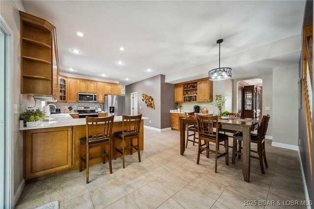 dining area featuring an inviting chandelier, baseboards, and recessed lighting
