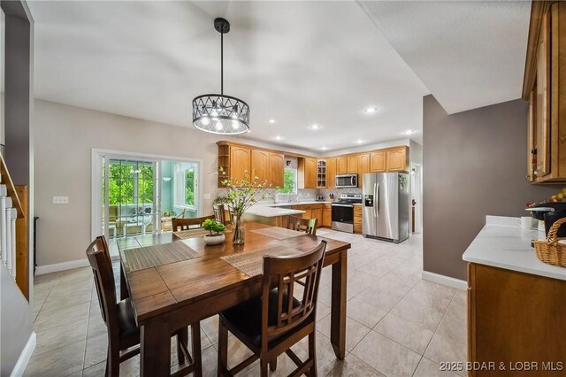 dining room featuring baseboards, recessed lighting, light tile patterned flooring, and a notable chandelier