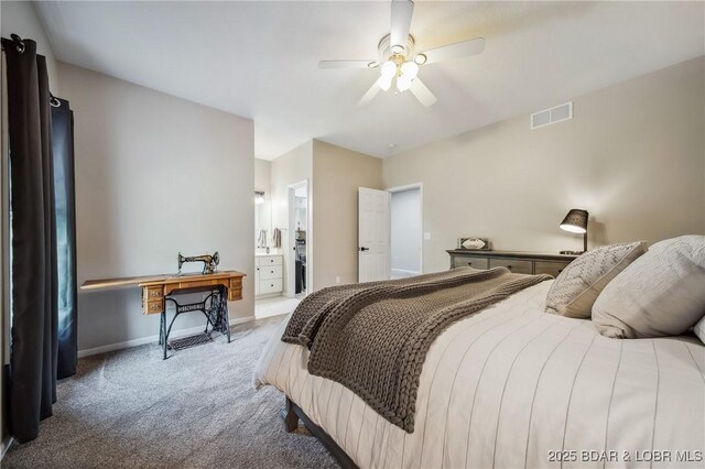 carpeted bedroom with baseboards, a ceiling fan, ensuite bath, and visible vents
