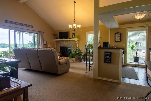 362 Hopetown Dr, Osage Beach, MO 65065 - carpeted living area with a stone fireplace, baseboards, a chandelier, and high vaulted ceiling