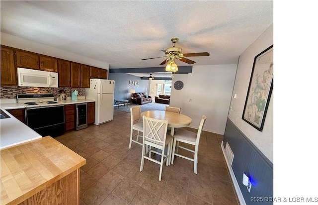 783 Winn Rd Unit 5F, Osage Beach, MO 65065 - kitchen featuring a ceiling fan, tasteful backsplash, light countertops, beverage cooler, and white appliances