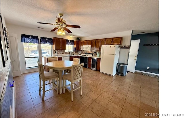 783 Winn Rd Unit 5F, Osage Beach, MO 65065 - dining area with baseboards, a textured ceiling, ceiling fan, and light tile patterned flooring